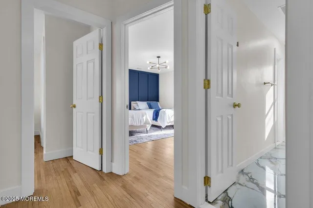 a bedroom with two beds and a potted plant