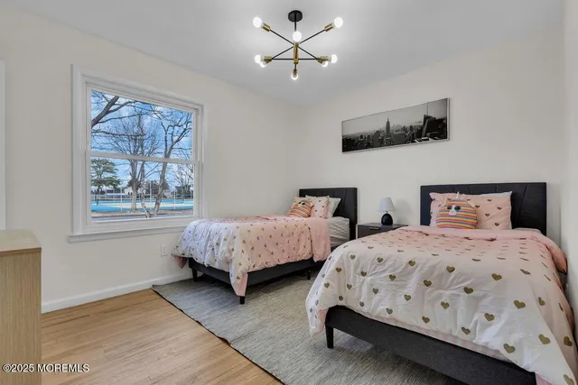 a spacious bedroom with bed and a potted plant
