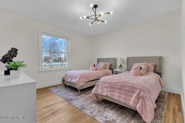 a bedroom with a large bed and a flat screen tv