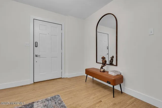 a living room with patio chairs and wooden floor