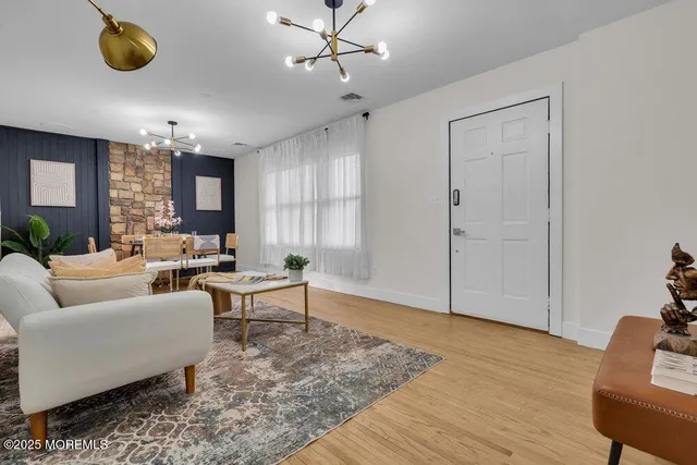 a living room with furniture and wooden floor