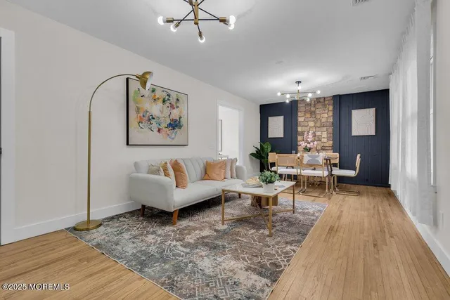 a kitchen with stainless steel appliances kitchen island granite countertop a sink a stove a microwave and cabinets