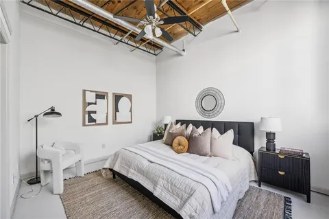 a bedroom with a bed and a window