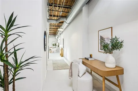 a living room with furniture and a potted plant