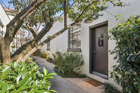 front view of a house with a tree