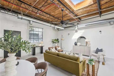 a living room with furniture and a potted plant