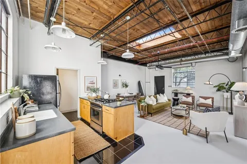 a kitchen with stainless steel appliances granite countertop a stove and a sink with cabinets