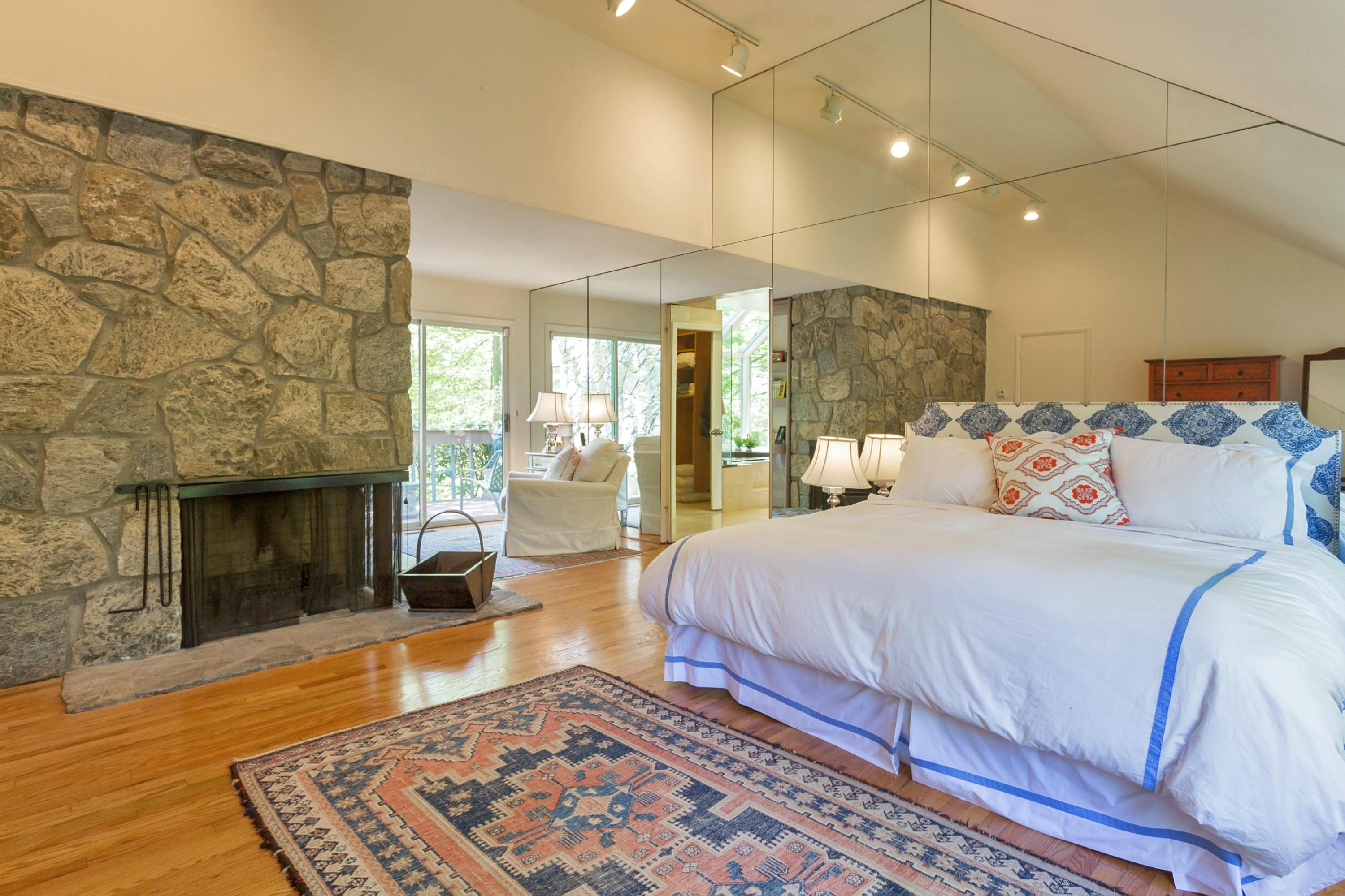 67 Sumner Road Greenwich, CT 06831 - Photo 11 of 25 a spacious bedroom with a bed and a fireplace