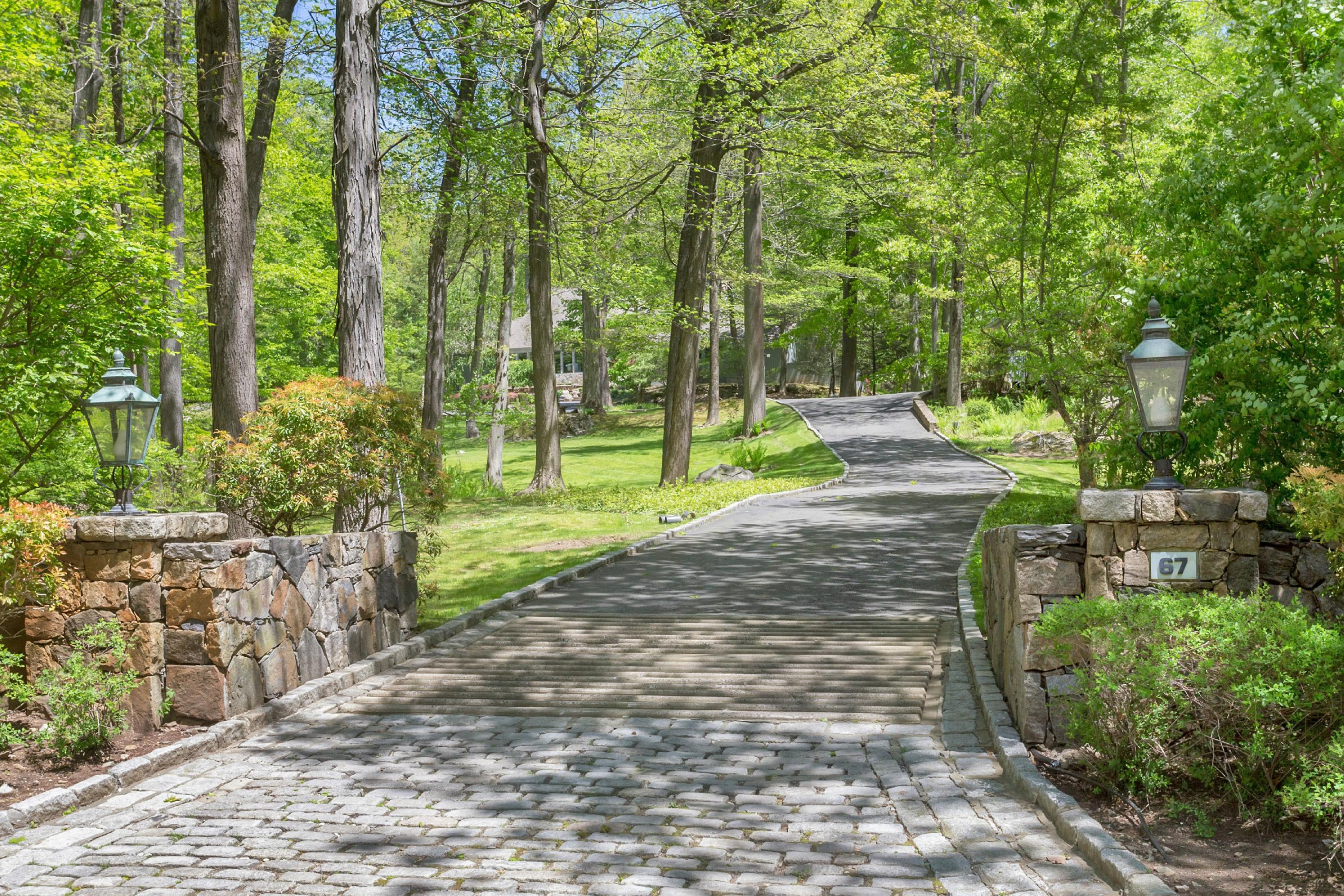 67 Sumner Road Greenwich, CT 06831 - Photo 2 of 25 a view of a yard with plants and large trees