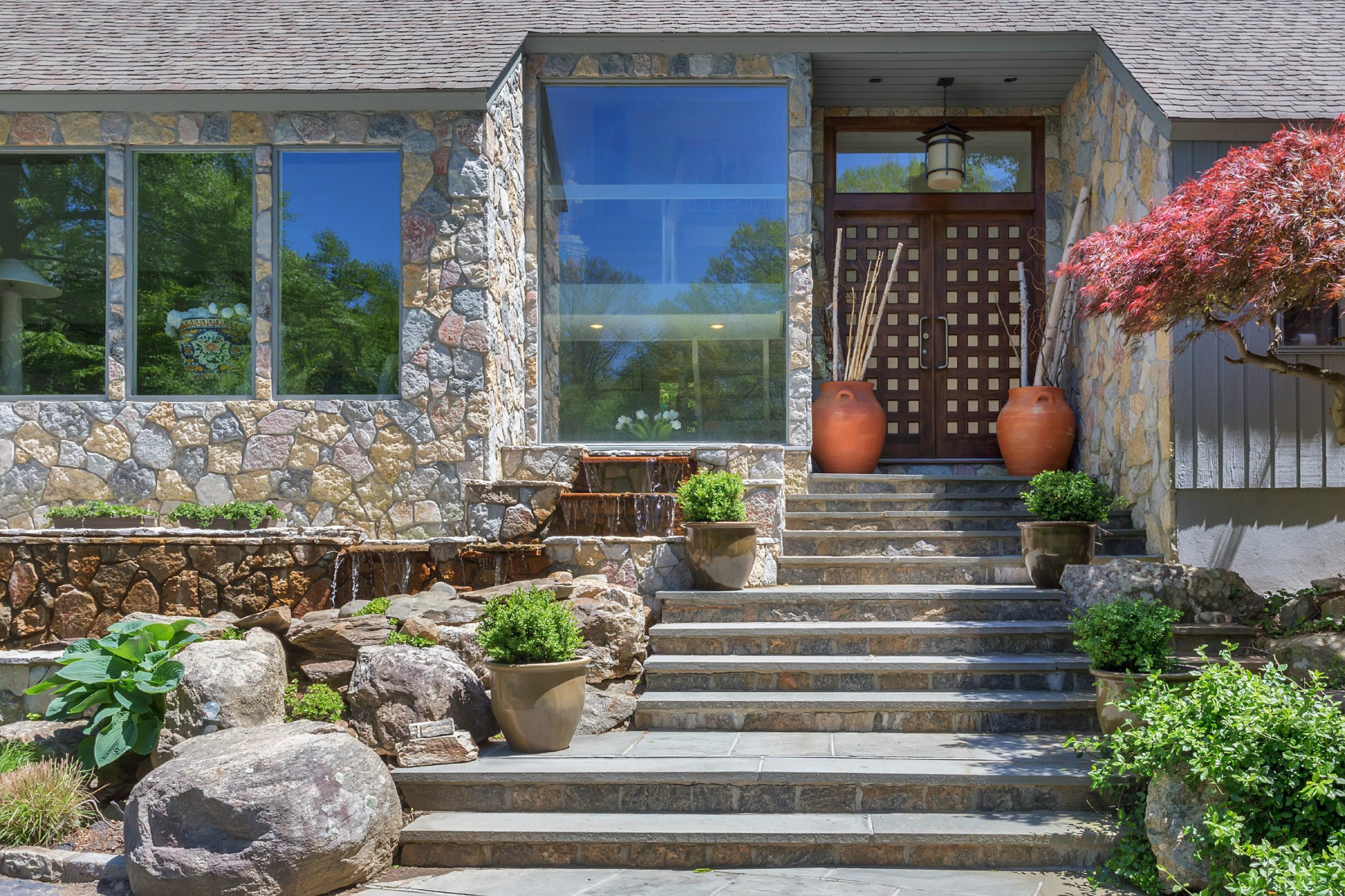 67 Sumner Road Greenwich, CT 06831 - Photo 3 of 25 a front view of a house with a yard