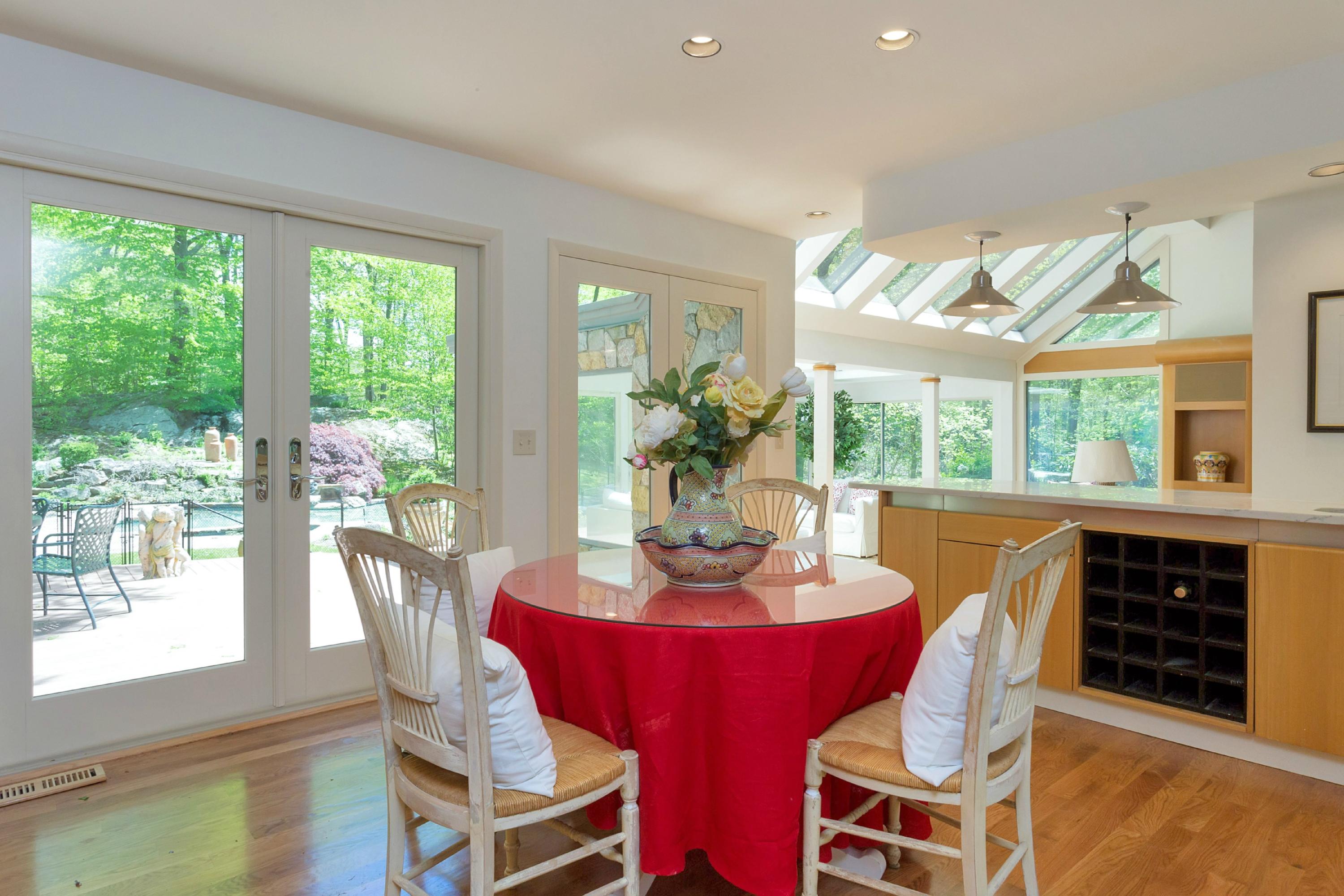 67 Sumner Road Greenwich, CT 06831 - Photo 7 of 25 a dining room with furniture a rug and a floor to ceiling window