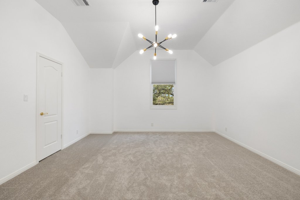 1815 Rue De St Tropez Austin, TX 78746 - Photo 18 of 39 Bonus room featuring lofted ceiling, a chandelier, and light carpet