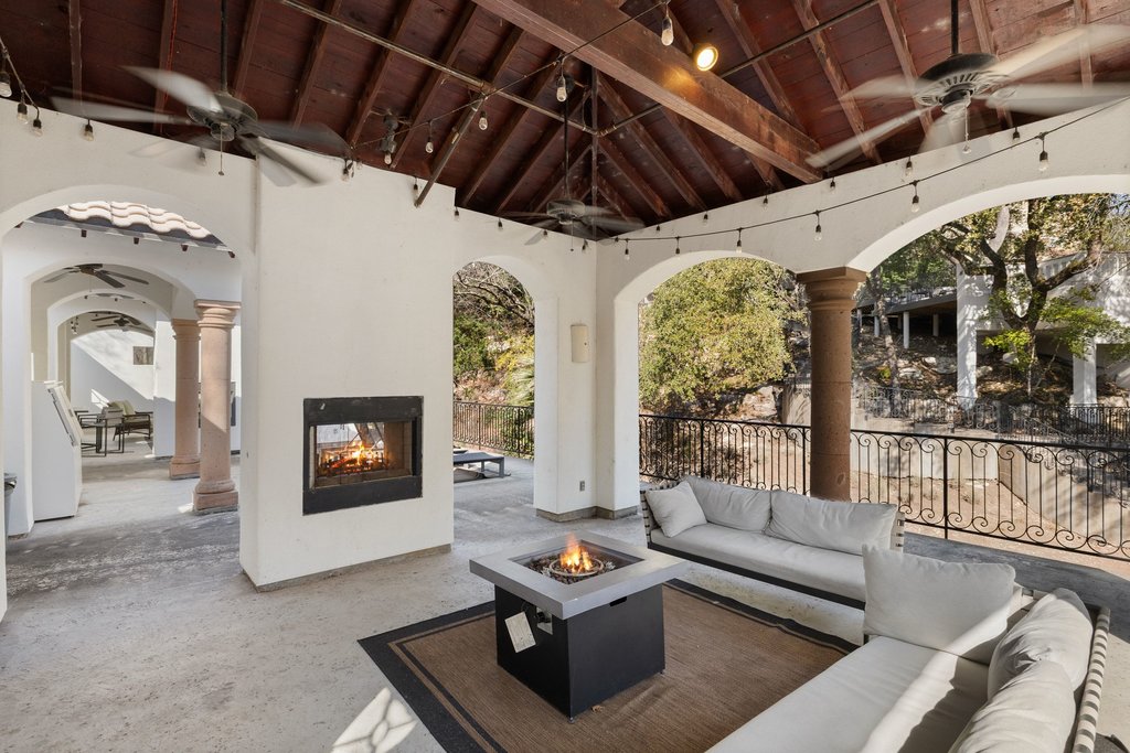 1815 Rue De St Tropez Austin, TX 78746 - Photo 29 of 39 View of patio featuring ceiling fan and an outdoor living space with a fireplace