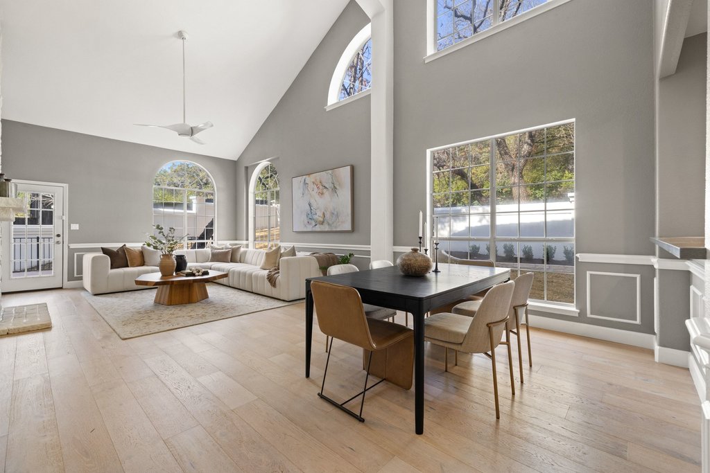1815 Rue De St Tropez Austin, TX 78746 - Photo 10 of 39 Dining room with light wood-type flooring, a decorative wall, lofted ceiling, and wainscoting