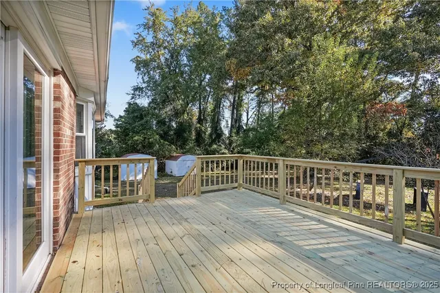 a balcony with wooden floor and fence