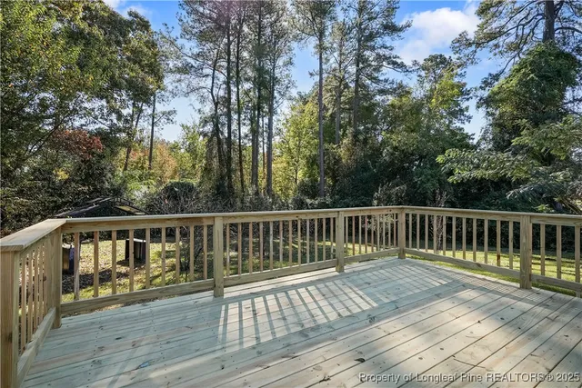 a view of balcony with wooden floor and fence