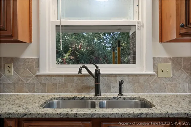 a kitchen with granite countertop a sink and a window