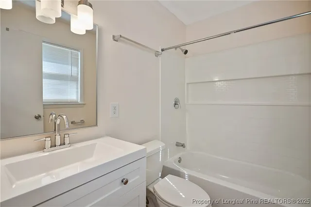 a bathroom with a sink toilet a mirror and shower