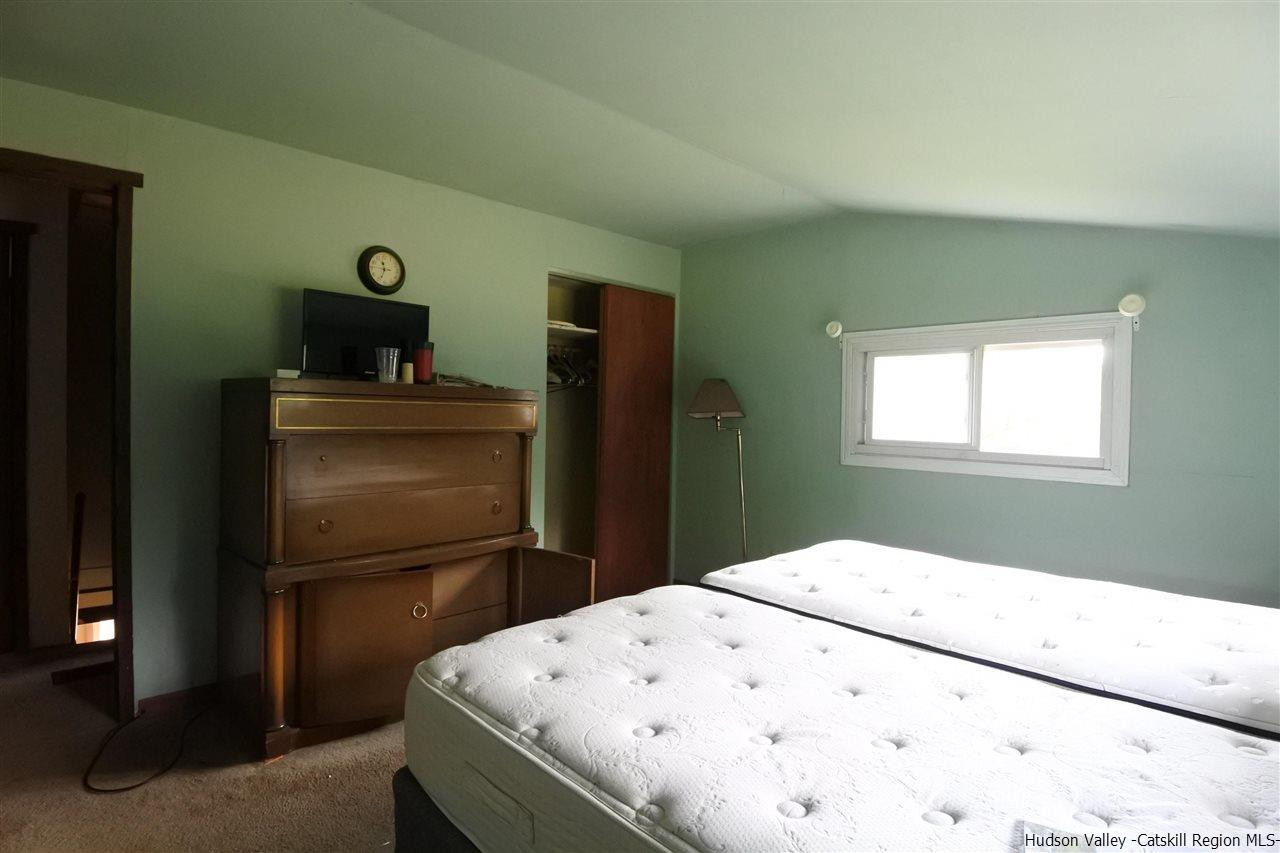 284 Bush Road Stone Ridge, NY 12484 - Photo 18 of 34 a bedroom with a bed and a television