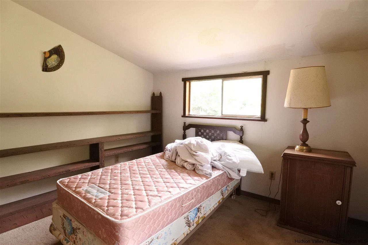 284 Bush Road Stone Ridge, NY 12484 - Photo 19 of 34 a bedroom with a bed and a window