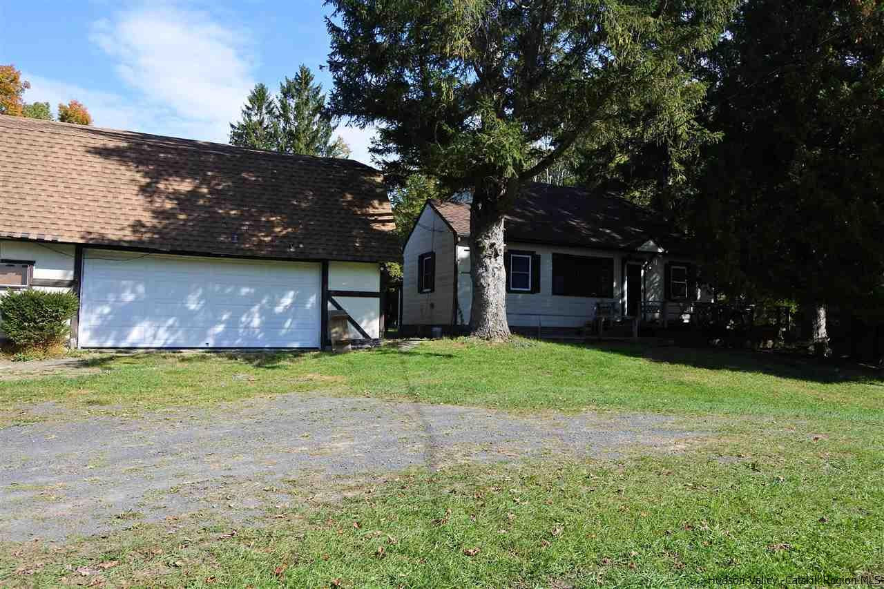 284 Bush Road Stone Ridge, NY 12484 - Photo 3 of 34 a brick house with a yard and large trees