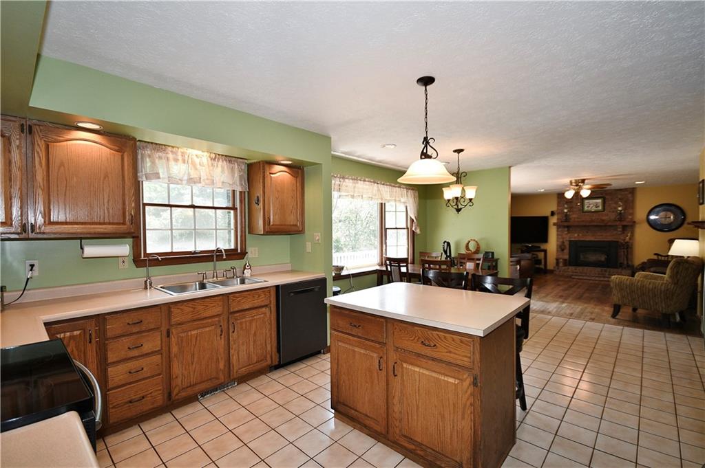 159 Klinger Road Canonsburg, PA 15317 - Photo 7 of 19 a large kitchen with kitchen island a sink a counter top space and living room view