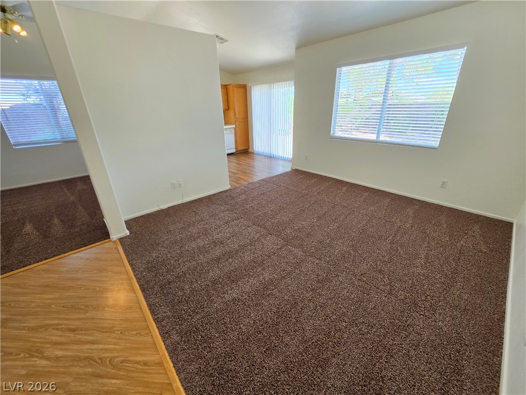 1154 Point Success Avenue Henderson, NV 89014 - Photo 7 of 26 A spacious living area awaits, featuring plush carpeting and generous natural light.