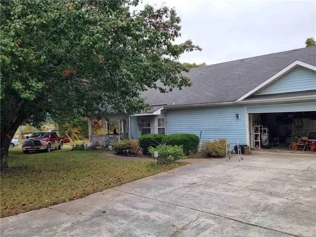 a view of a house with a yard and garage