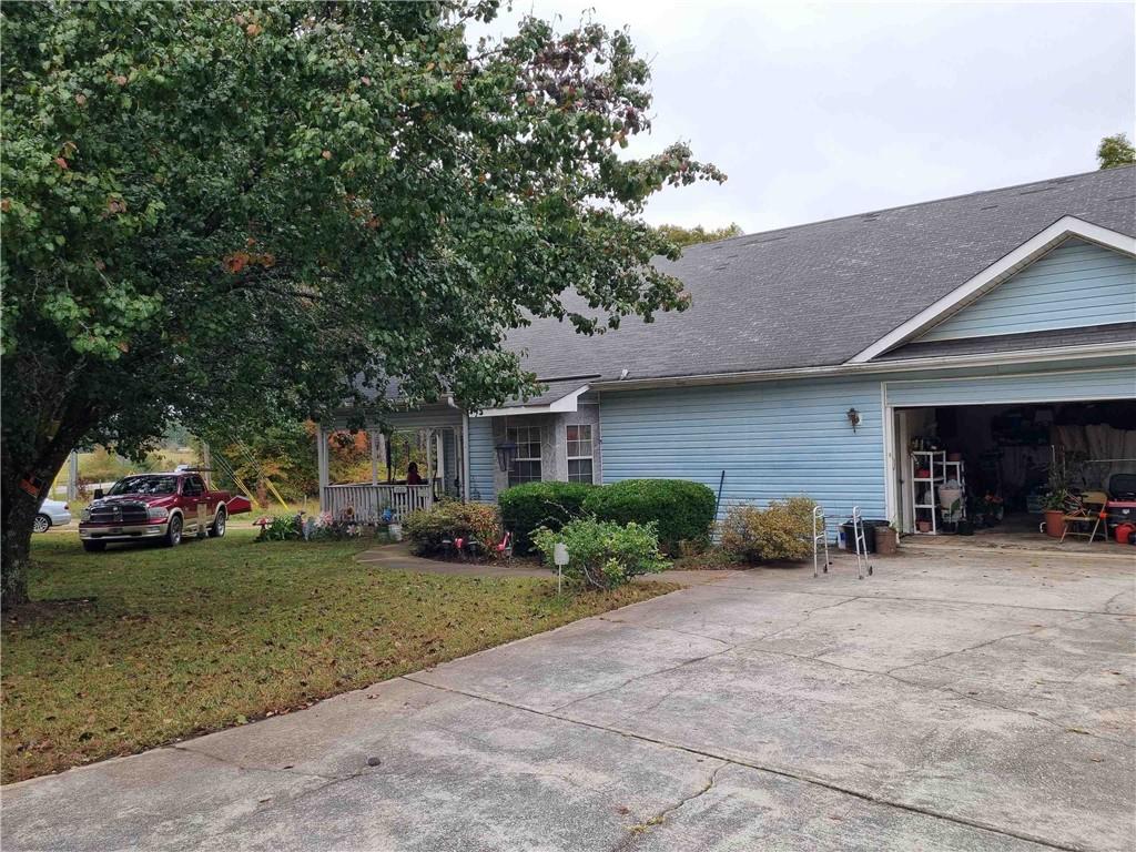a view of a house with a yard and garage