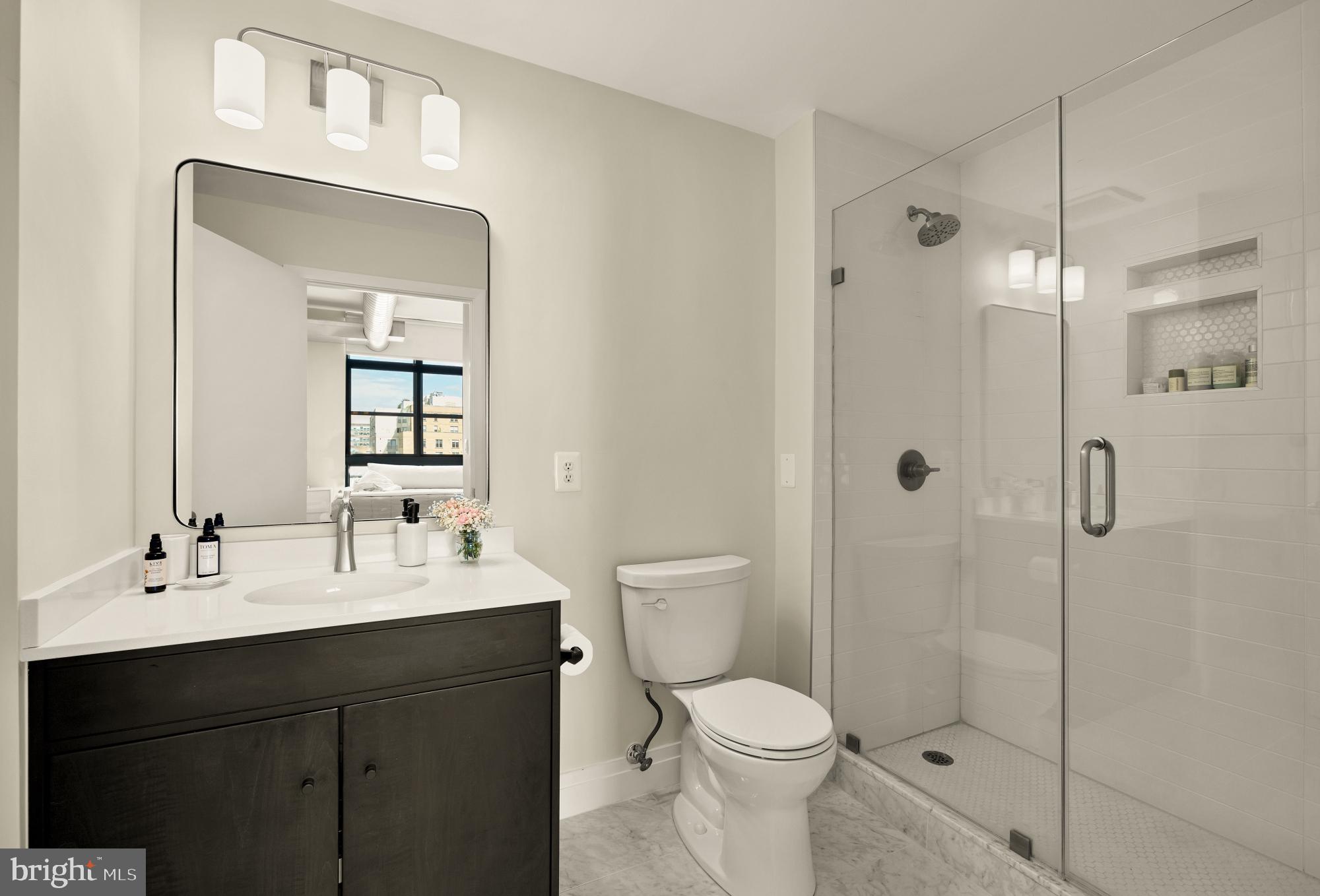 2020 12th Street Northwest, Unit 518 Washington, DC 20009 - Photo 13 of 28 a bathroom with a sink a toilet and shower