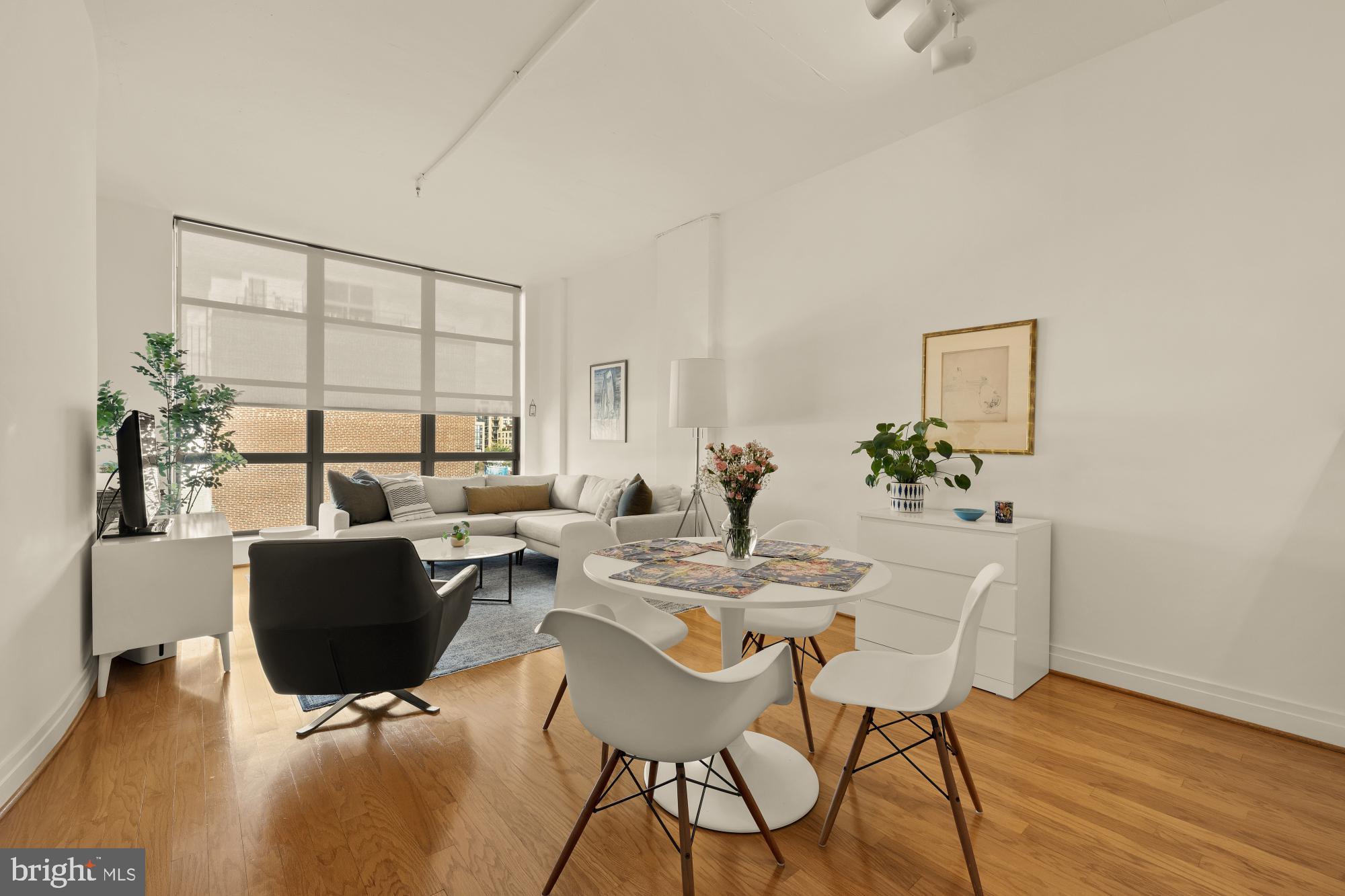 2020 12th Street Northwest, Unit 518 Washington, DC 20009 - Photo 3 of 28 a view of a dining room with furniture and wooden floor