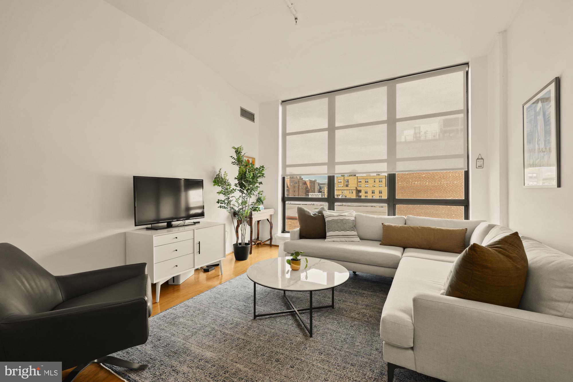 2020 12th Street Northwest, Unit 518 Washington, DC 20009 - Photo 9 of 28 a living room with furniture and a flat screen tv
