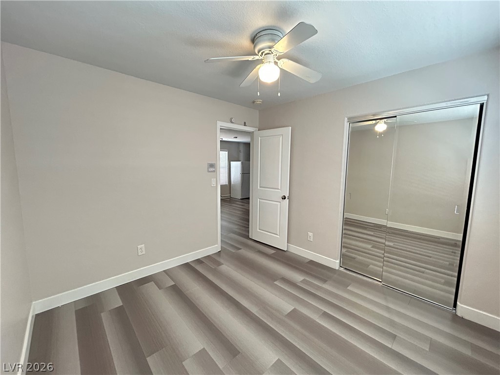6538 Elm Spring Las Vegas, NV 89148 - Photo 20 of 29 A well-lit bedroom features durable laminate flooring and a ceiling fan, enhancing comfort and style.