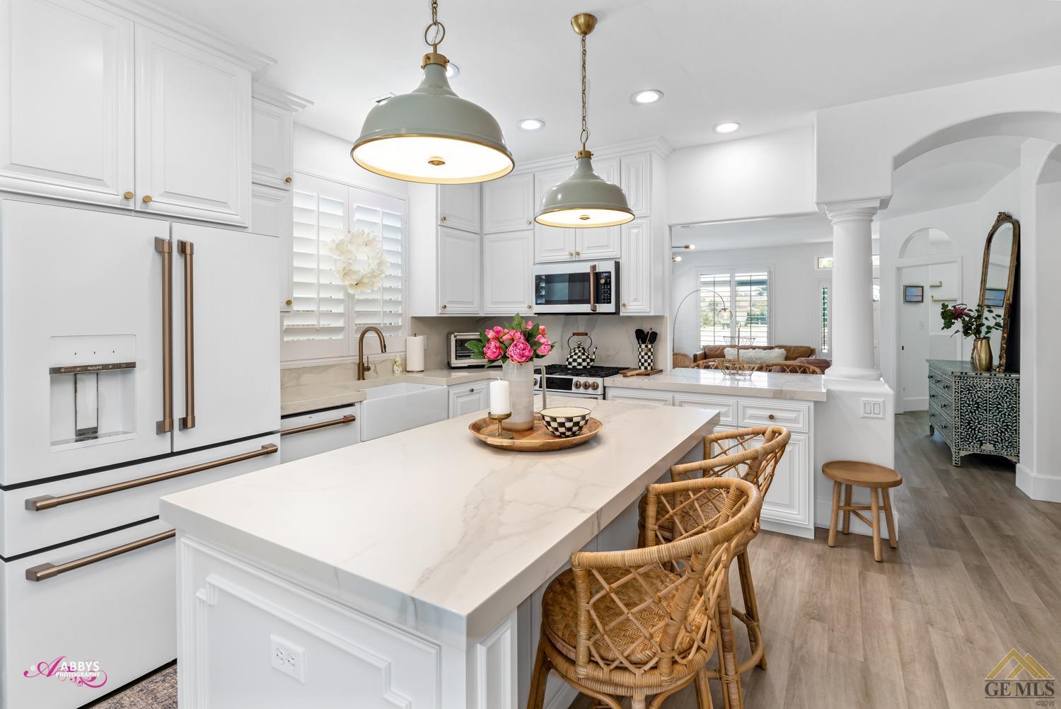 Undisclosed Address Bakersfield, CA 93311 - Photo 15 of 48 a kitchen with stainless steel appliances kitchen island granite countertop a table chairs and a stove