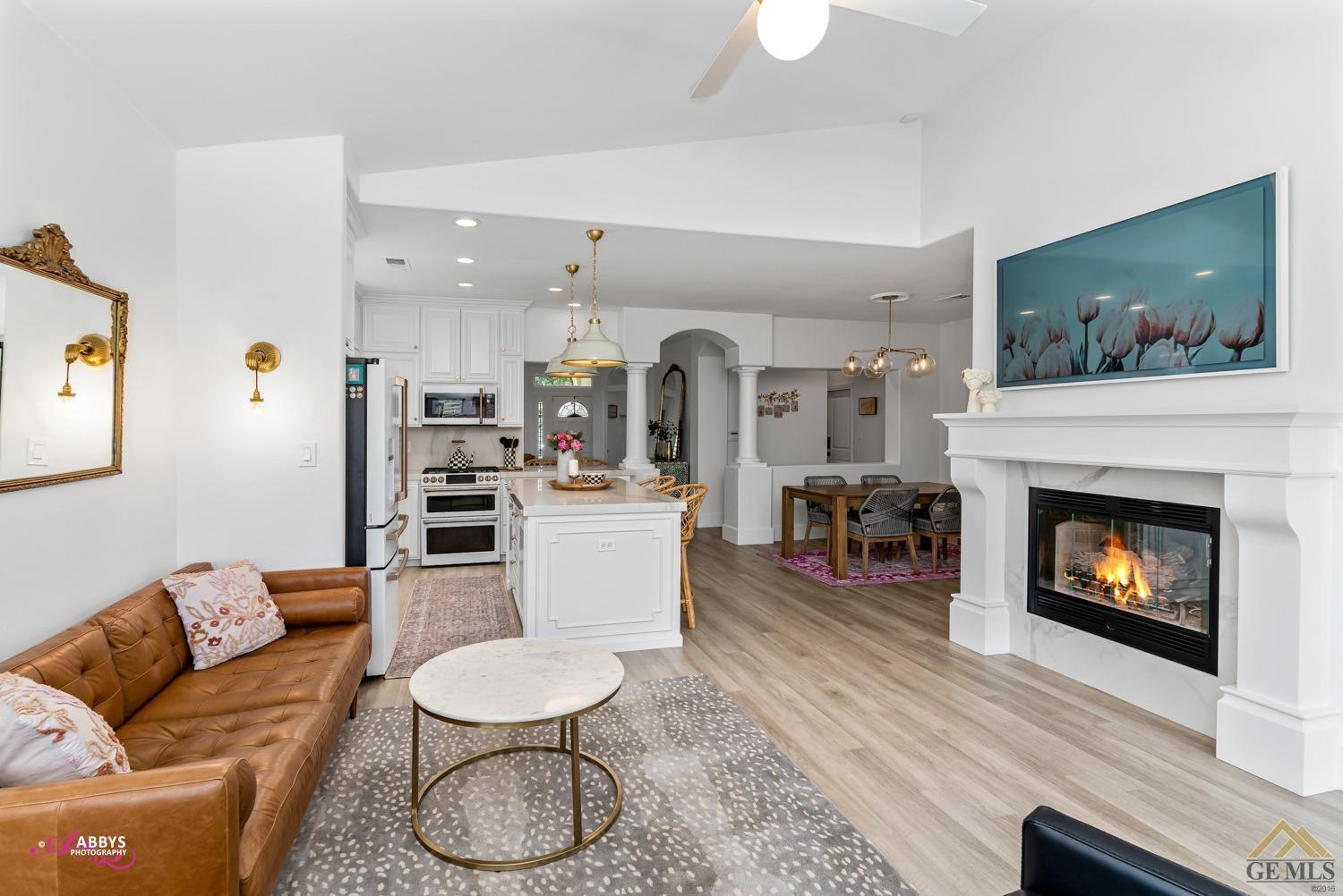 Undisclosed Address Bakersfield, CA 93311 - Photo 22 of 48 a living room with furniture a fireplace and a flat screen tv