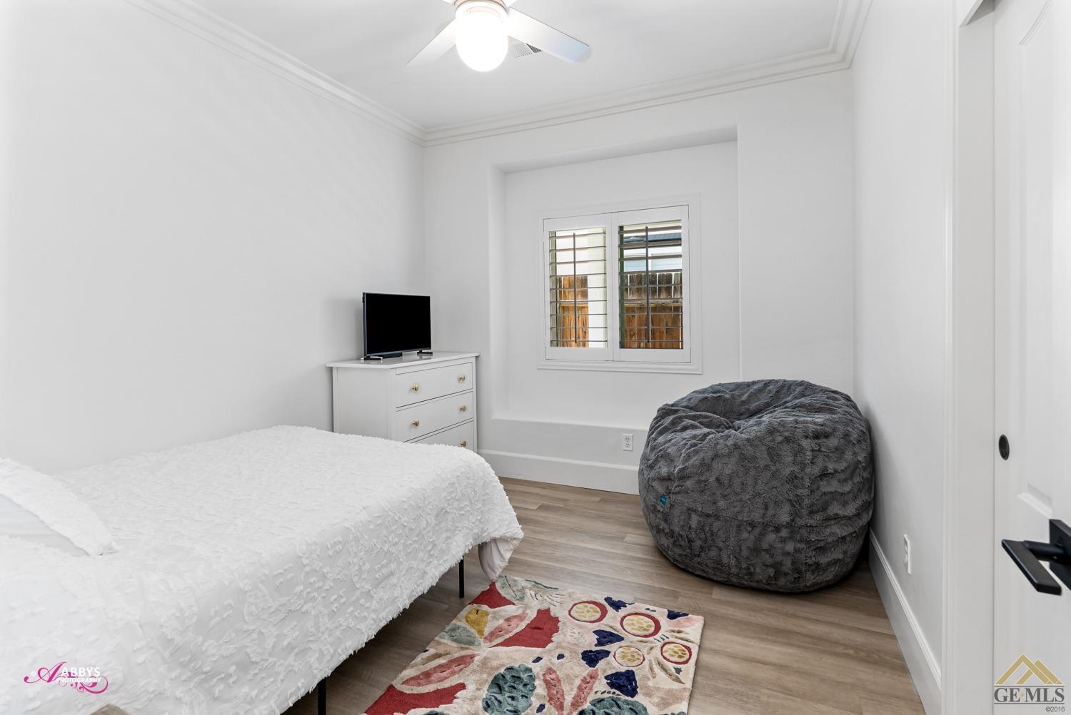 Undisclosed Address Bakersfield, CA 93311 - Photo 24 of 48 a bedroom with a bed a flat tv screen and a dresser