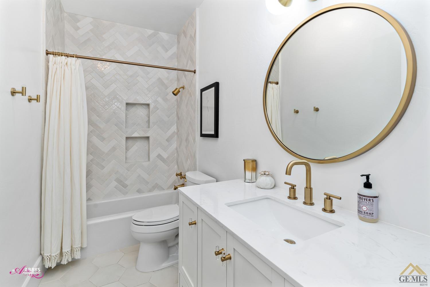 Undisclosed Address Bakersfield, CA 93311 - Photo 25 of 48 a bathroom with a sink a toilet and a mirror