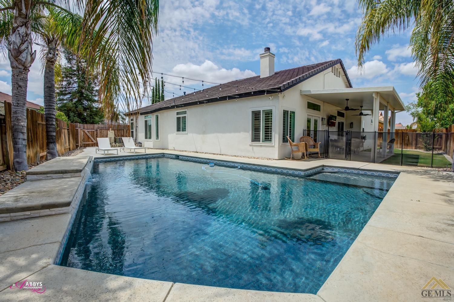 Undisclosed Address Bakersfield, CA 93311 - Photo 41 of 48 Sparkling pool with bistro lighting and plenty of decking for lounging.