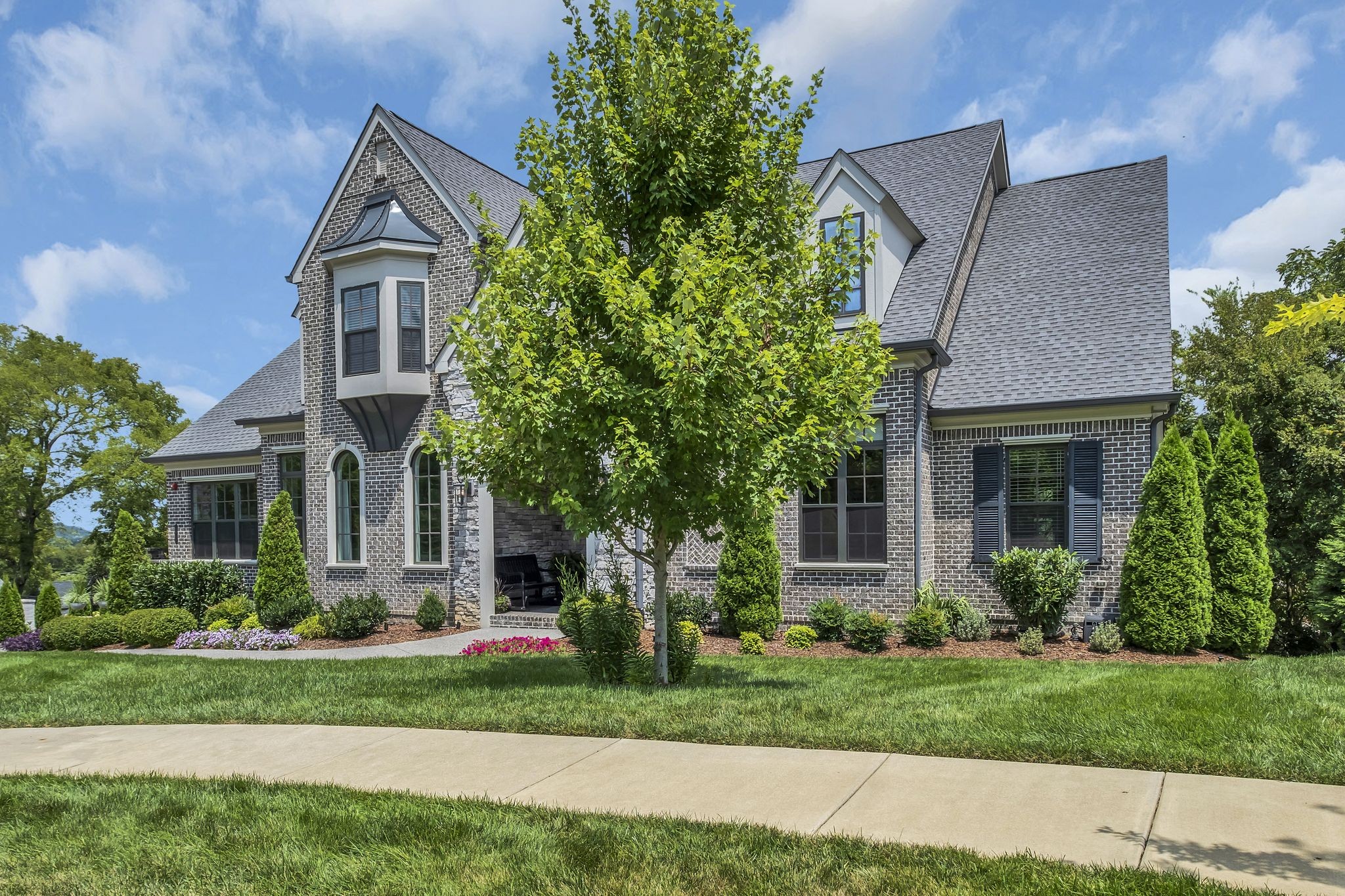 1043 Firestone Drive Franklin, TN 37067 - Photo 3 of 61 a front view of a house with a garden and plants