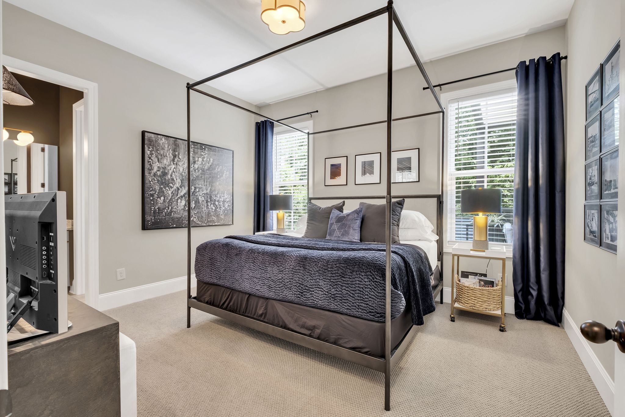 1043 Firestone Drive Franklin, TN 37067 - Photo 35 of 61 a bedroom with a large bed and a flat tv screen on the dresser