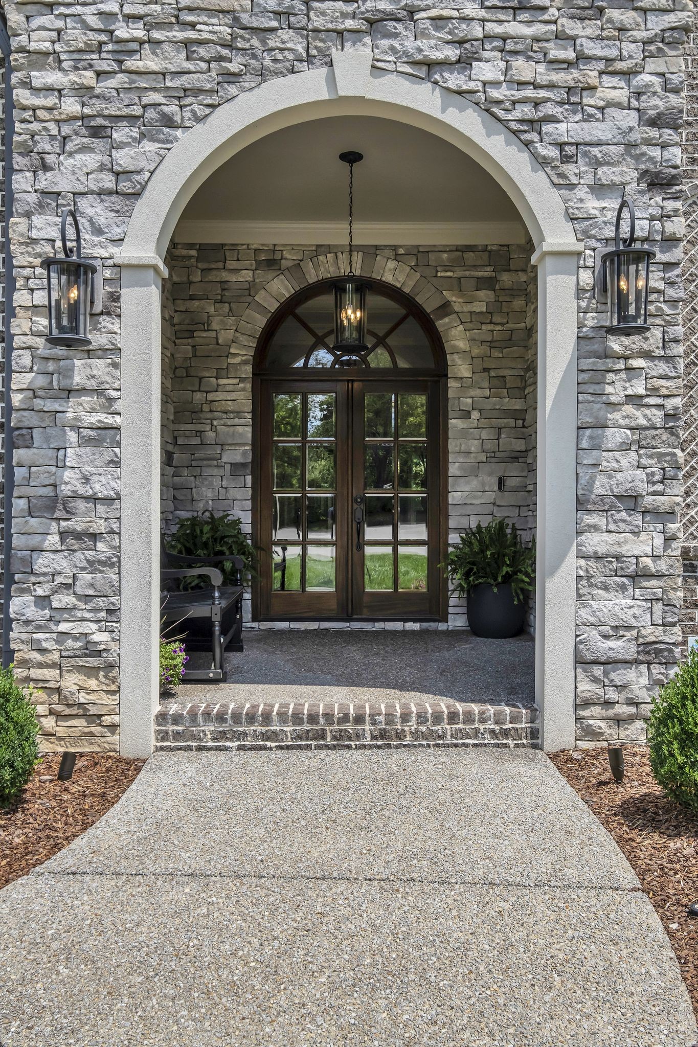 1043 Firestone Drive Franklin, TN 37067 - Photo 4 of 61 a front view of a house with a garden