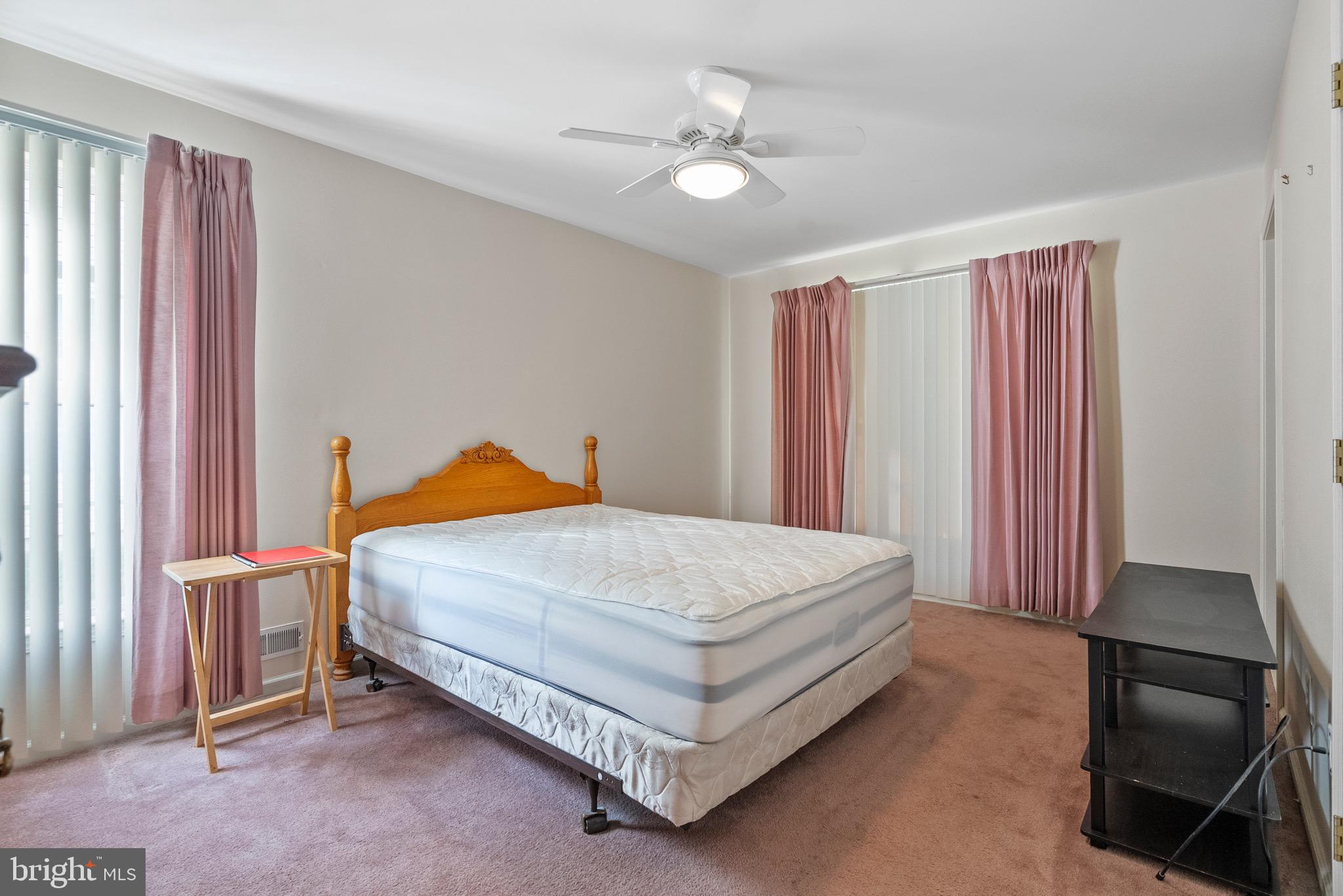 26 Carriage Berlin, NJ 08009 - Photo 14 of 19 a bed sitting in a spacious bedroom next to a window