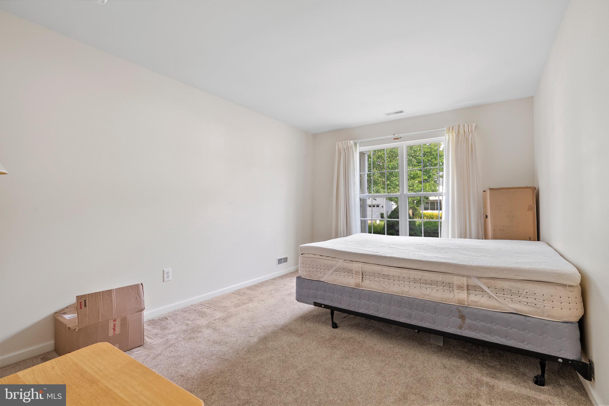 26 Carriage Berlin, NJ 08009 - Photo 15 of 19 a bedroom with a bed and window