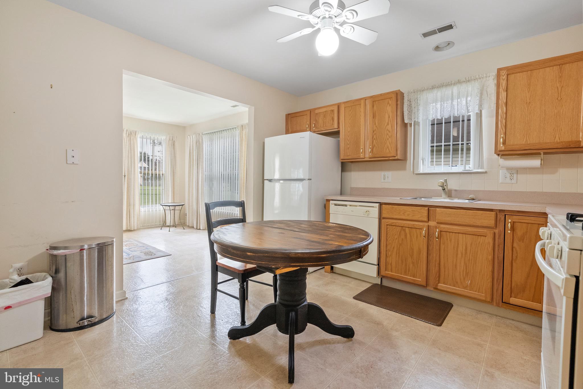 26 Carriage Berlin, NJ 08009 - Photo 6 of 19 a kitchen with a table chairs sink and refrigerator