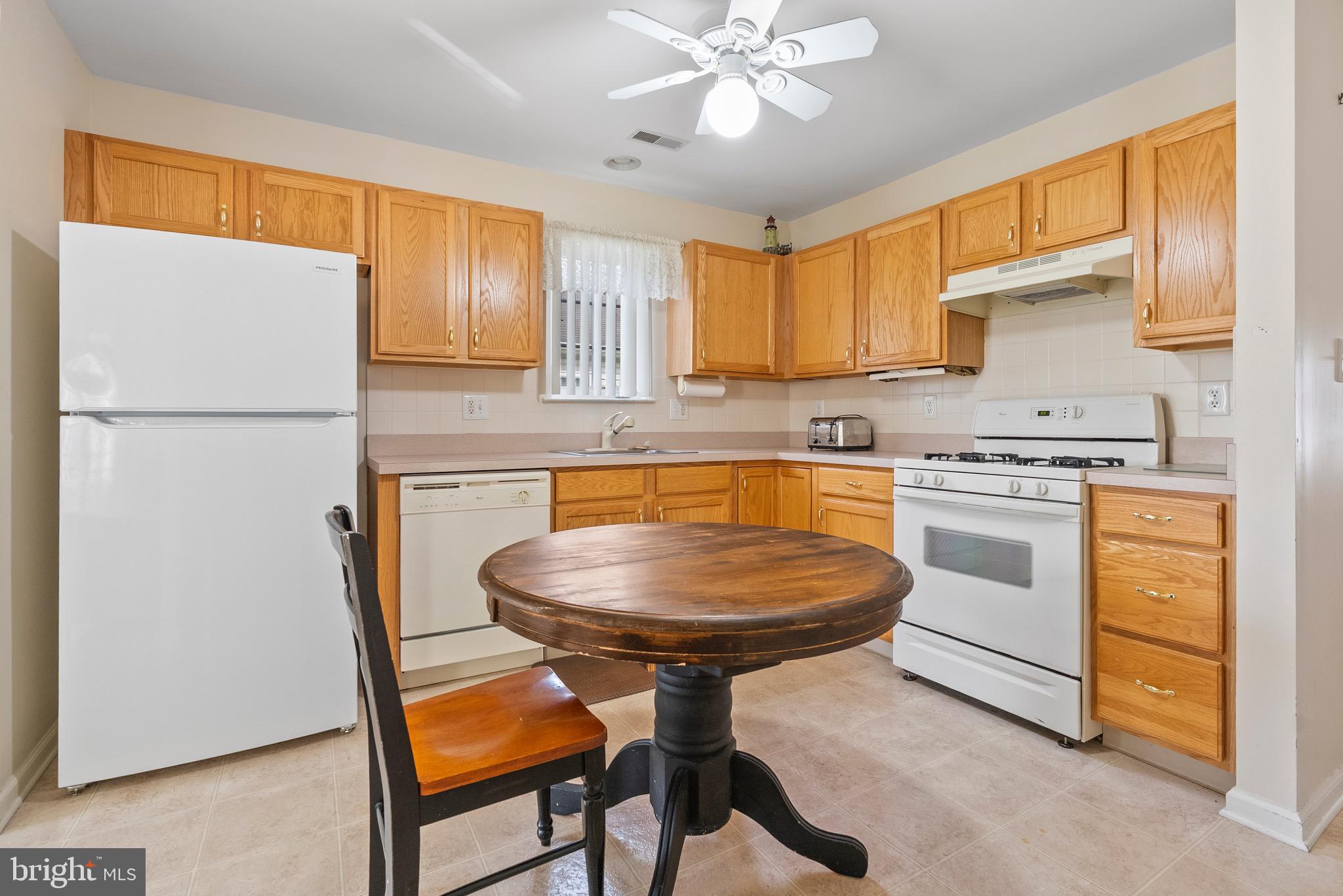 26 Carriage Berlin, NJ 08009 - Photo 7 of 19 a kitchen with stainless steel appliances a refrigerator a stove a sink cabinets and a dining table
