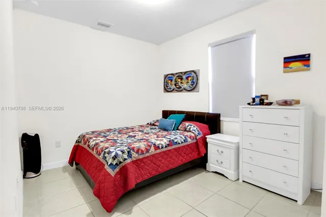 a bedroom with a bed and dresser