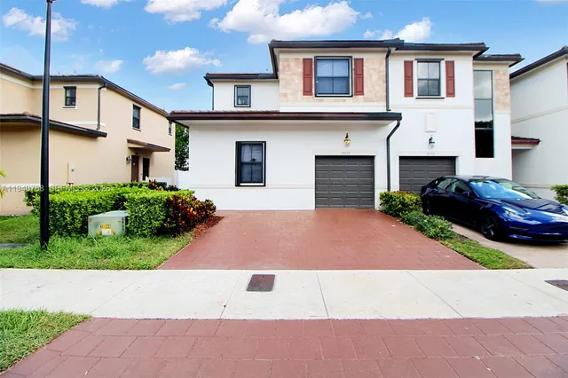 a front view of a house with yard
