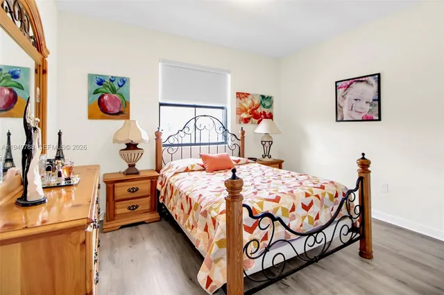 a bedroom with bed and paintings on the wall