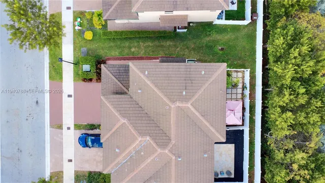 an aerial view of a house with a yard basket ball court and outdoor seating