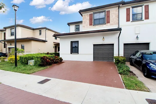 a front view of a house with a yard and garage